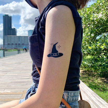fake small witch magic sorting hat illustrative temporary tattoo sticker design idea on upper arm