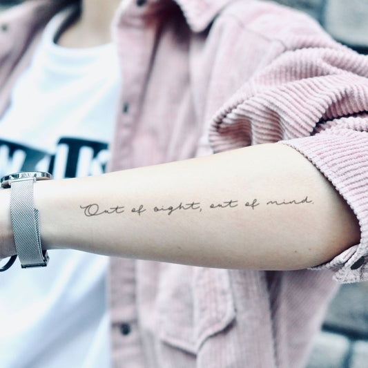 fake medium out of sight out of mind quote lettering temporary tattoo sticker design idea on forearm