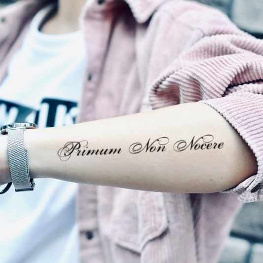 fake medium primum non nocere lettering temporary tattoo sticker design idea on forearm