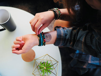 fake small heart in a circle labyrinth maze mandala geometric temporary tattoo sticker design idea on wrist